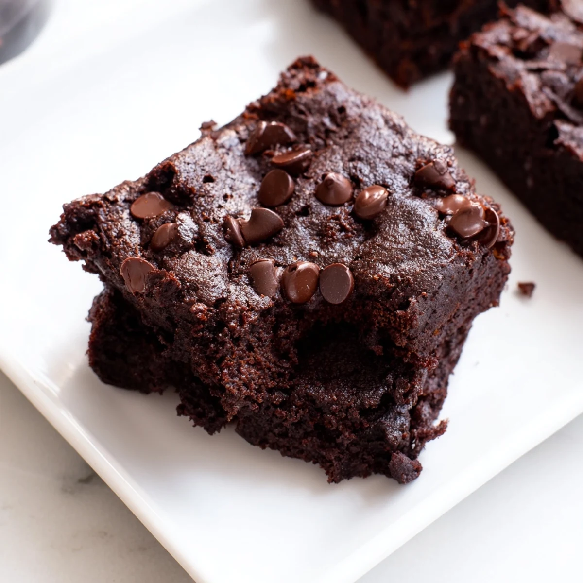Fudgy Greek yogurt brownies, topped with melting chocolate chips, promise a decadent, guilt-free treat.