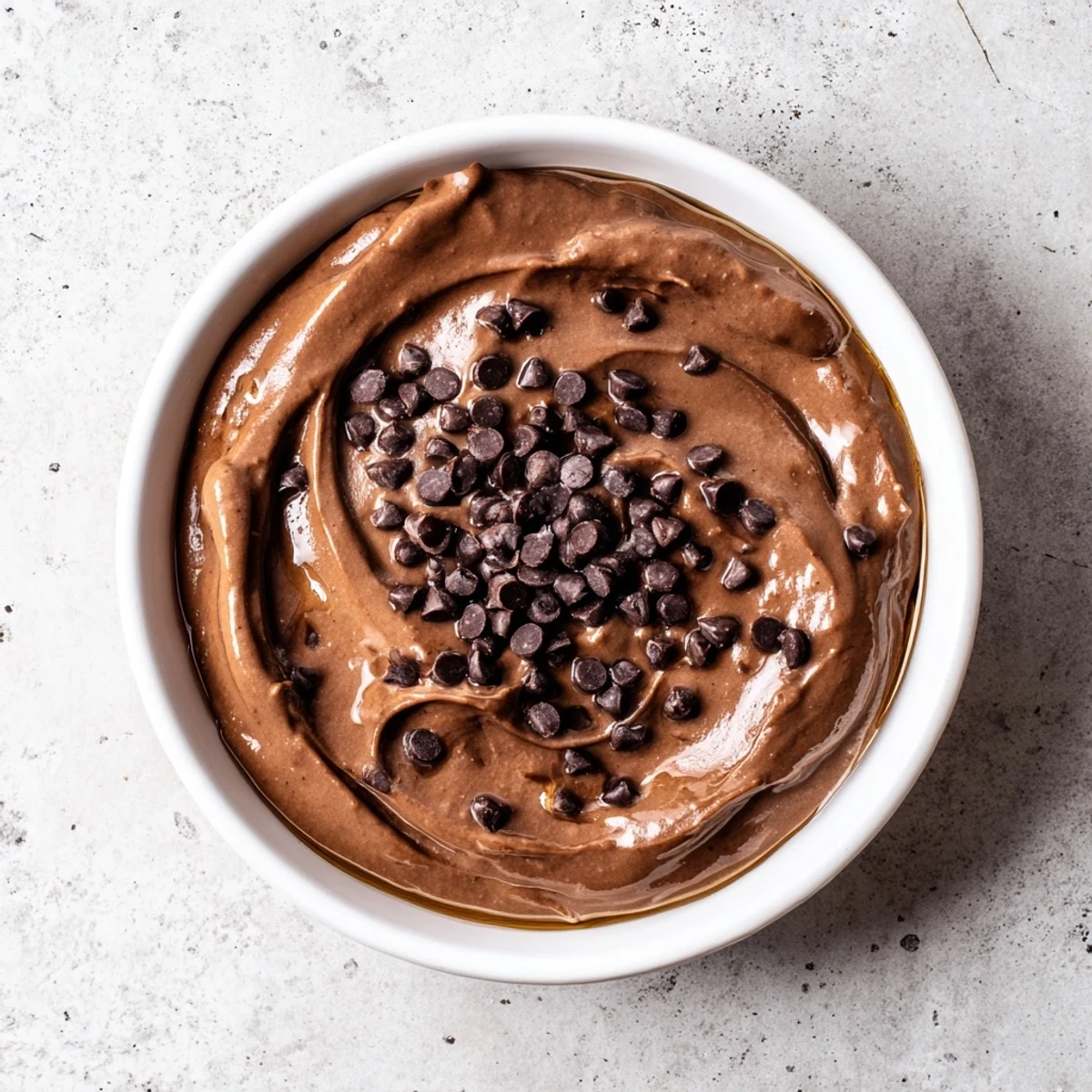 Close-up of decadent chocolate hummus, perfect for dipping fruits or spreading on toast.