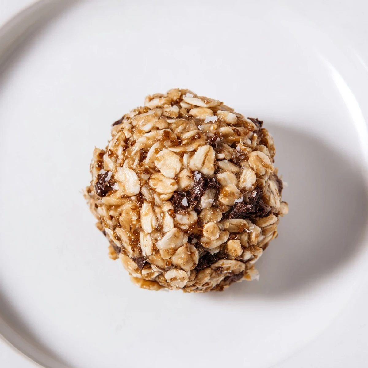 Perfectly round Almond-Chia Energy Bites arranged on parchment, a healthy, no-bake treat.