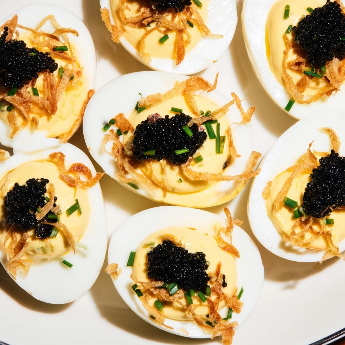 Luscious deviled eggs: creamy filling contrasted by briny caviar and crispy, golden shallots on top.