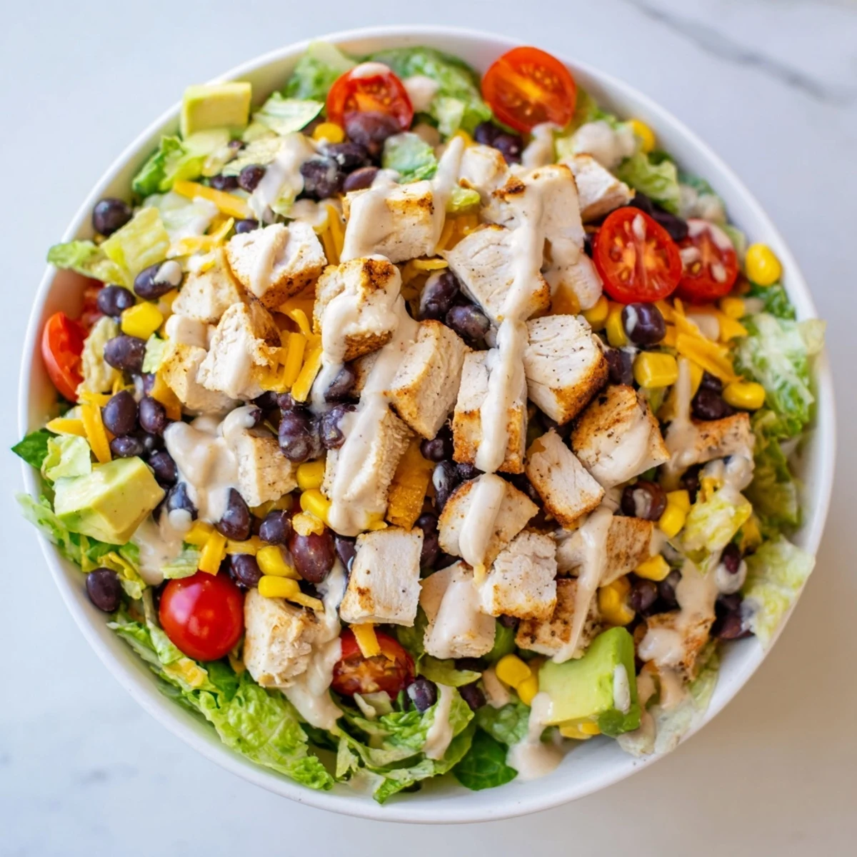 Juicy chopped chicken and diced avocado mingle in this colorful Chicken Taco Chopped Salad, perfect for a quick weeknight meal.