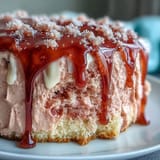 Delicate rosé-infused velvet cake layers frosted with creamy cheese frosting, crowned with shimmering gold drip for a stunning bridal shower dessert.  