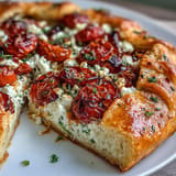 Savory Mediterranean galette featuring sweet tomatoes, creamy feta, perfect for sharing.