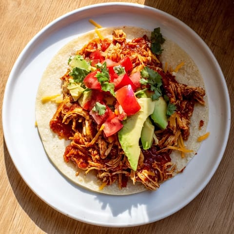 Glimpse the tender slow cooker shredded chicken tacos, ready to be filled with fresh toppings and served.