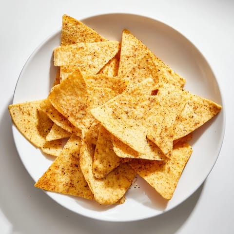 Homemade air-fryer tortilla chips, seasoned with paprika and cumin, ready for a delicious snack.