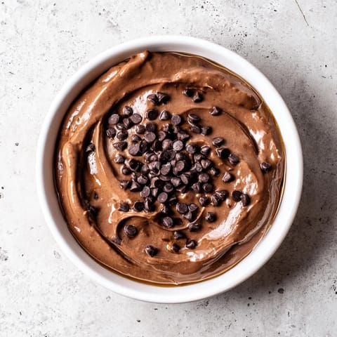 Close-up of decadent chocolate hummus, perfect for dipping fruits or spreading on toast.