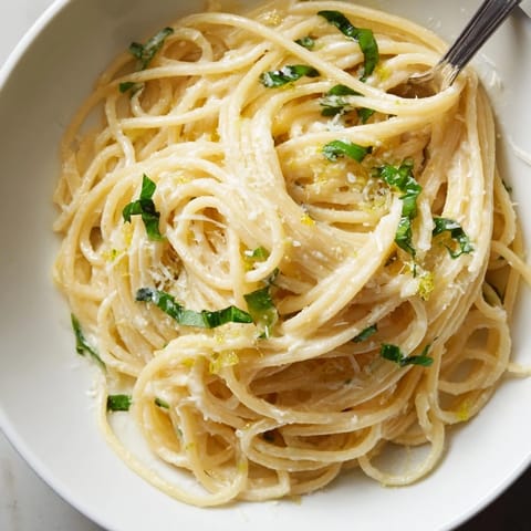 Steaming plate of lemon ricotta pasta, garnished with extra zest and black pepper for a zesty weeknight dinner.  