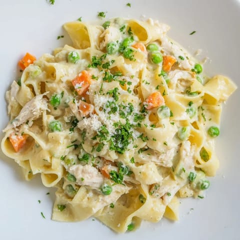Spring Chicken Noodle Skillet features al dente egg noodles, shredded chicken, and vibrant spring vegetables in a light parmesan cream sauce.  
