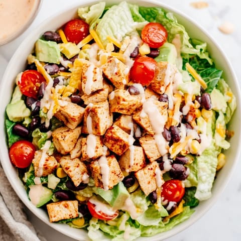 Freshly crushed tortilla chips top this hearty Chicken Taco Chopped Salad, adding a satisfying crunch to every Tex-Mex bite.