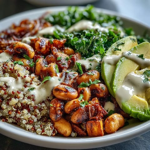 Healthy Black-Eyed Pea Buddha Bowl topped with avocado slices, fresh spinach, and a drizzle of zesty lemon-tahini sauce.