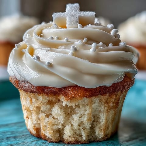 Tender vanilla communion cupcakes topped with sweet buttercream and delicate fondant crosses.