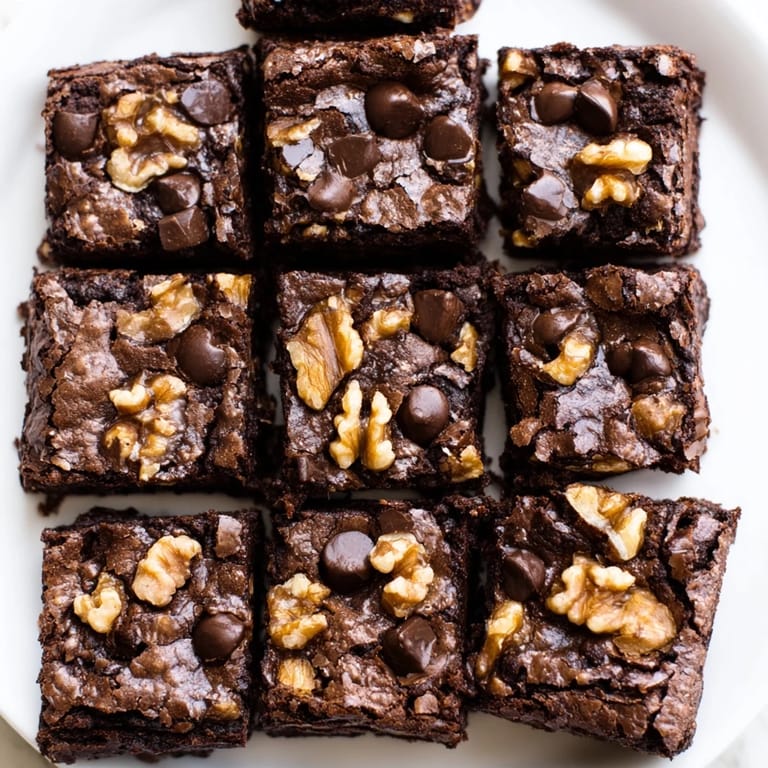 Freshly baked fudgy walnut brownies: a rich chocolate aroma with crunchy walnuts and perfect edges.