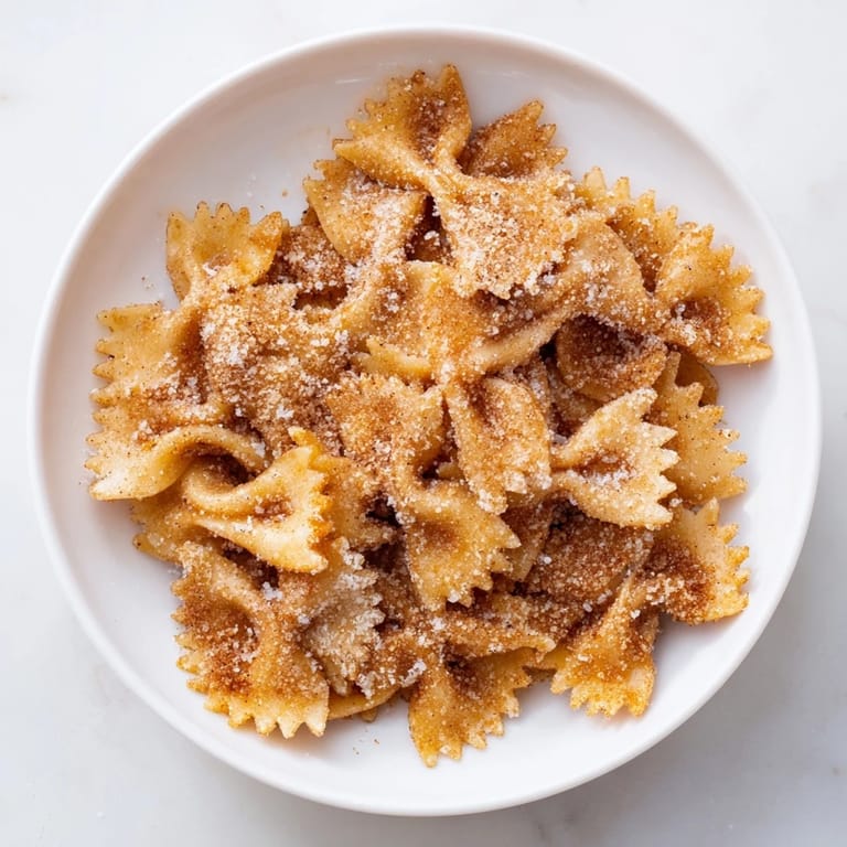 Close-up of crispy Air Fryer Pasta Christmas Crack, a holiday snack with a dusting of cinnamon and sugar.