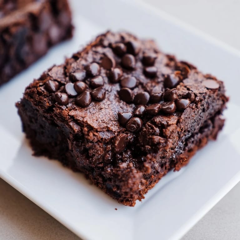 Warm, dark, and tempting: Close-up of sliced Greek yogurt brownies ready to be enjoyed with a coffee.