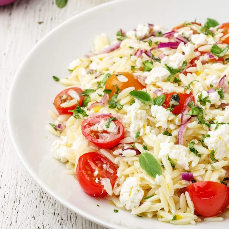 A colorful bowl of Tomato Feta Orzo, perfect for a light lunch or a delightful side dish.
