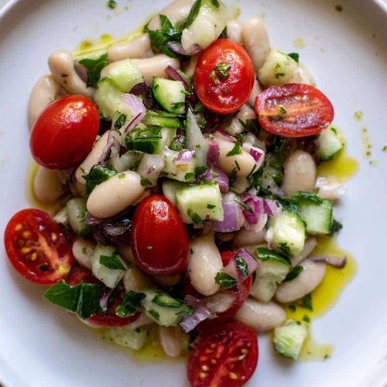 This refreshing white bean salad showcases creamy cannellini beans tossed with juicy vegetables.