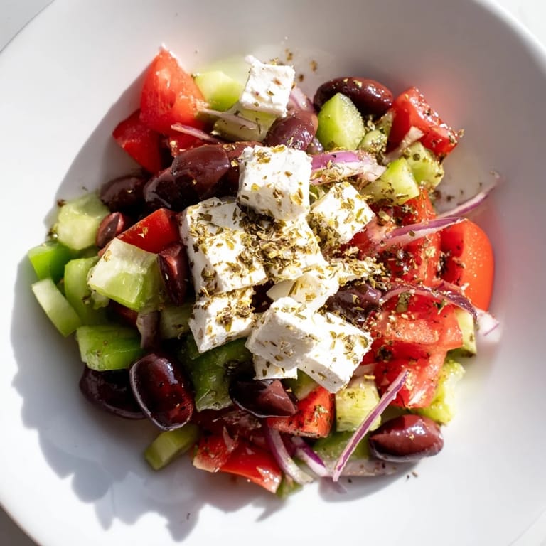 A close-up of a refreshing Mediterranean Salad; see the vibrant colors and creamy feta cheese.