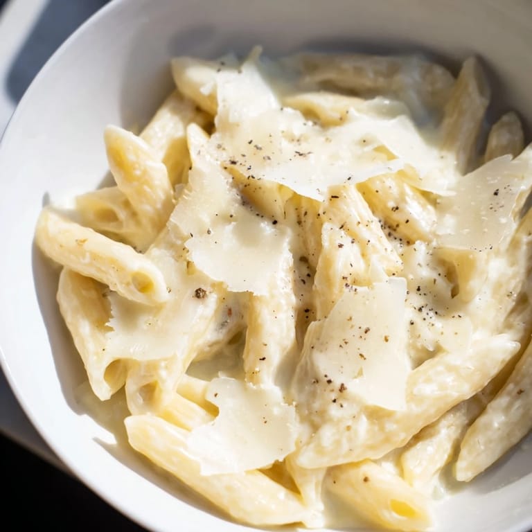 Fork-twirling Creamy Milk Pasta One-Pot rests in a shallow bowl, garnished with fresh parsley and melted Parmesan, perfect for cozy dinners.  
