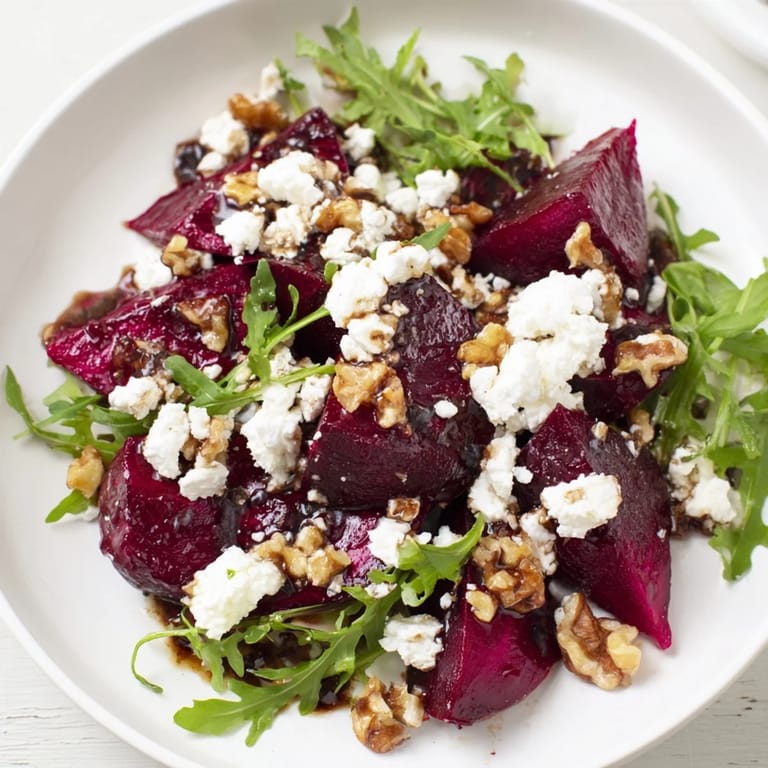 Hearty roasted beet goat cheese salad garnished with fresh herbs, ready to serve at an American dinner table.