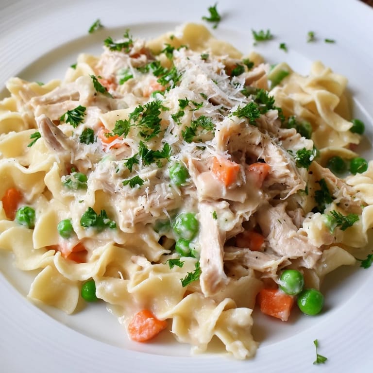 Family-style Spring Chicken Noodle Skillet in a rustic skillet, garnished with fresh parsley and ready to serve with crusty bread.