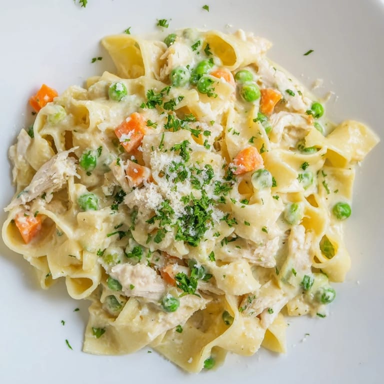 Spring Chicken Noodle Skillet features al dente egg noodles, shredded chicken, and vibrant spring vegetables in a light parmesan cream sauce.  