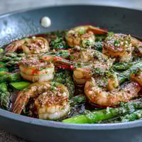 Healthy Easy One-Pan Lemon Garlic Shrimp and Asparagus with vibrant citrus aroma and tender roasted vegetables in a savory garlic-infused olive oil.